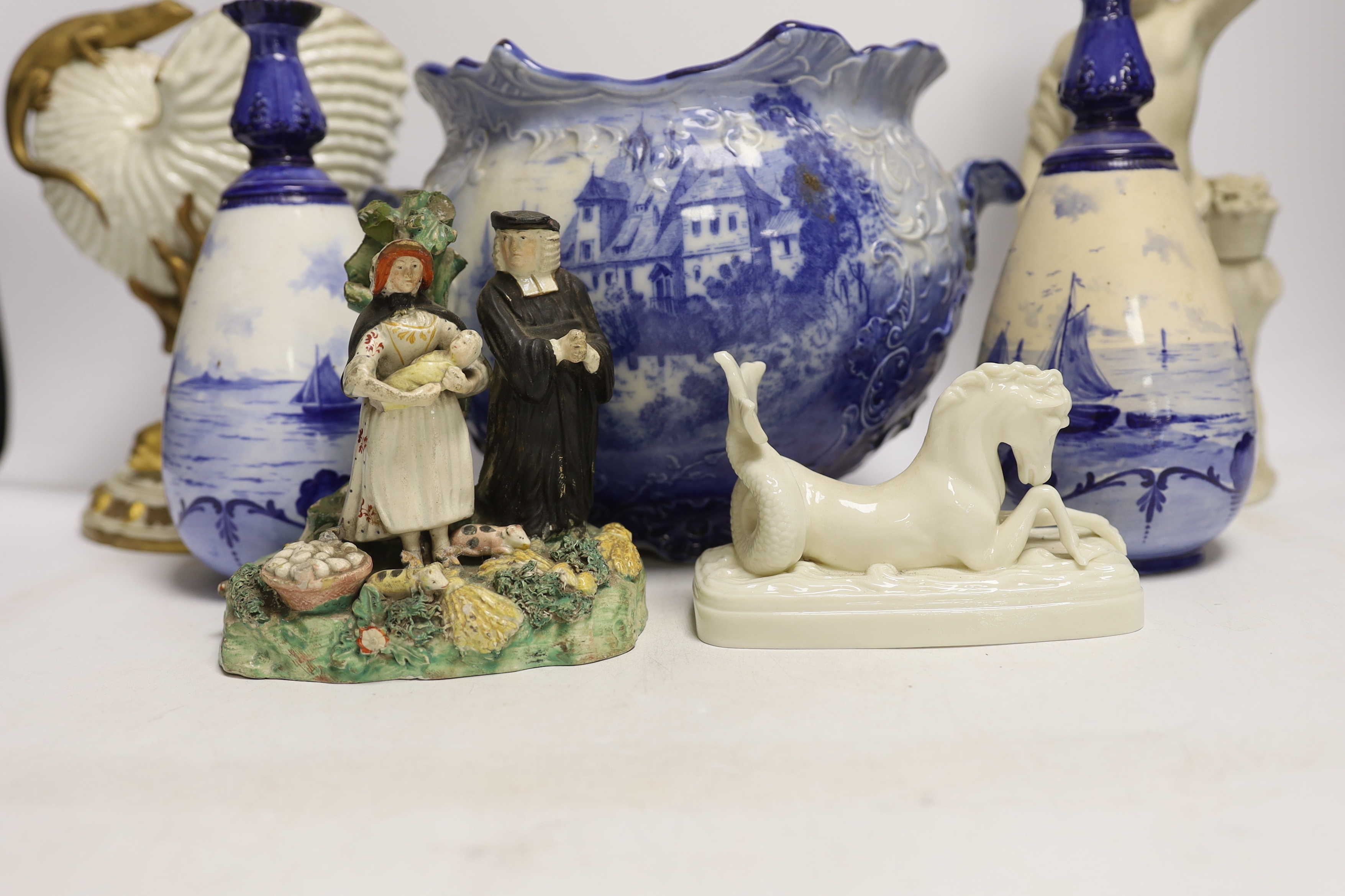 A 19th century Staffordshire Tithe Pig group, a pair of Royal Crown Derby blue and white vases, a Royal Worcester nautilus shell centrepiece and three other items, 32cm high